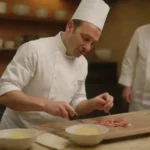 Chef capturando la preparación paso a paso de un plato tradicional con notas e ingredientes mostrados.